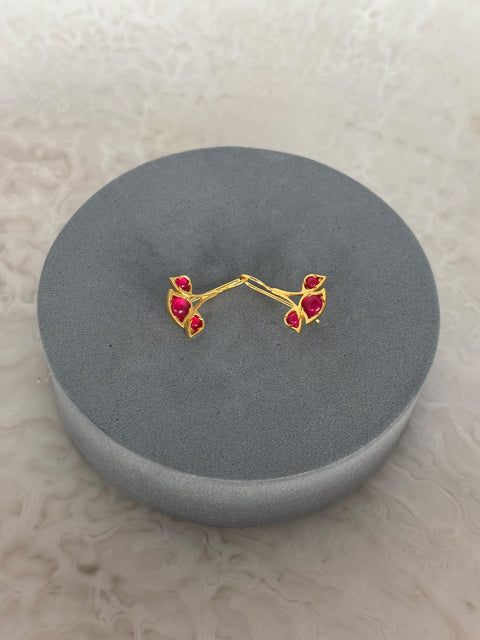 Side View of Sterling Silver Gold Plated Nayantara Red Quartz Earrings on Grey Pillow