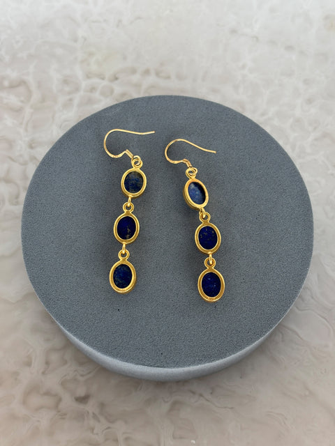 Angled Shot of Zara Gold Plated Sterling Silver with 3 Chain Linked Lapis Lazuli Earrings on Soft Pillow