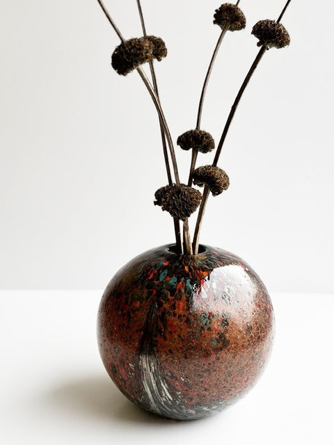Lifestyle Shot of Crimson Fiery Marble Sphere Handmade & Handblown Large Glass Vase