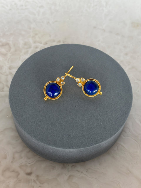 Front Shot of Amaya Sterling Silver Gold Plated Dangle Lapiz Lazuli Earrings on Grey Pillow