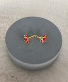 Side View of Sterling Silver Gold Plated Nayantara Red Quartz Earrings on Grey Pillow
