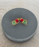 Angled Shot of Roshni Sterling Silver Gold Plated Dangle Earrings with Aventurine and Red Quartz Gem on a Grey Soft Pillow