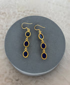 Angled Shot of Zara Gold Plated Sterling Silver with 3 Chain Linked Lapis Lazuli Earrings on Soft Pillow