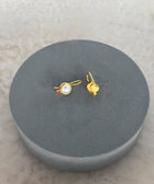 Rear Shot of Charvi Sterling Silver Gold Plated Pearl Earrings Handcrafted in Jaipur On a Grey Pillow