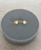 Side Shot of Charvi Sterling Silver Gold Plated Pearl Earrings Handcrafted in Jaipur On a Grey Pillow