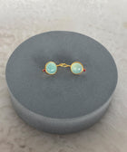 Side Shot of Charvi Sterling Silver Gold Plated Aqua Chalcedony Earrings Handcrafted in Jaipur On a Grey Pillow