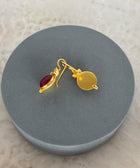 Rear View of Amaya Sterling Silver Gold Plated Dangle Red Quartz Earrings on Grey Pillow