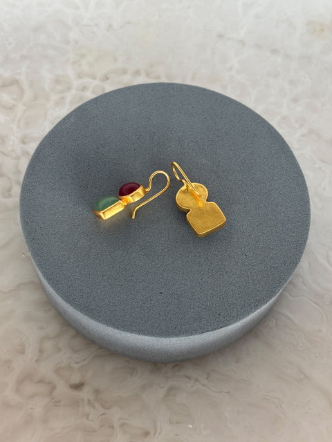 Rear Facing Shot of Roshni Sterling Silver Gold Plated Dangle Earrings with Aventurine and Red Quartz Gem on a Grey Soft Pillow