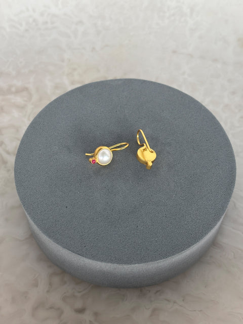 Rear Shot of Charvi Sterling Silver Gold Plated Pearl Earrings Handcrafted in Jaipur On a Grey Pillow